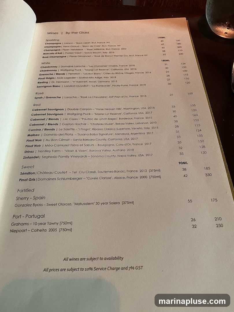 A wine list with sparkling, white, rosé, red, sweet, fortified, and port selections, with prices for 150ML, 90ML, and 750ML servings. All wines are subject to availability, and prices include a 10% service charge and 7% GST.