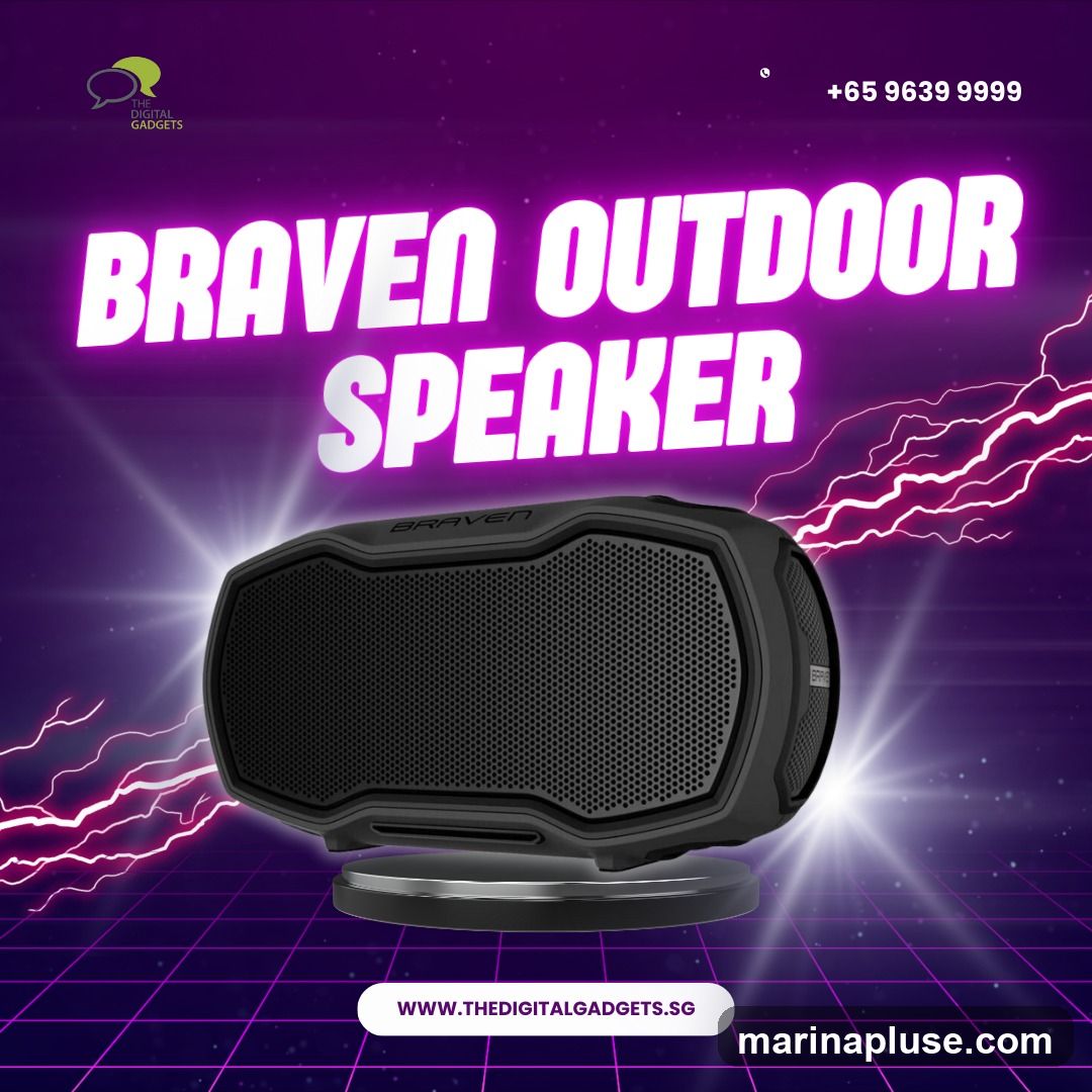 A digital advertisement for a Braven outdoor speaker. The speaker is black and prominently displayed in the center of the image. The background is a dark purple with a grid pattern and stylized lightning effects. Text at the top reads "BRAVEN OUTDOOR SPEAKER" in large, glowing purple letters. A phone number, "+65 9639 9999", and a website, "WWW.THEDIGITALGADGETS.SG", are also visible. The logo for "THE DIGITAL GADGETS" is in the top left corner.