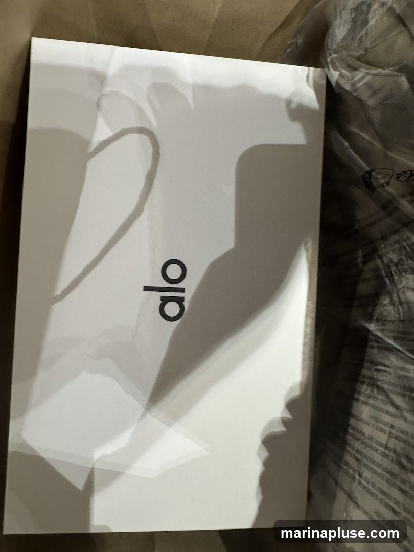 A white box with the black logo 'alo' is shown. The box appears to be packaging for a product.