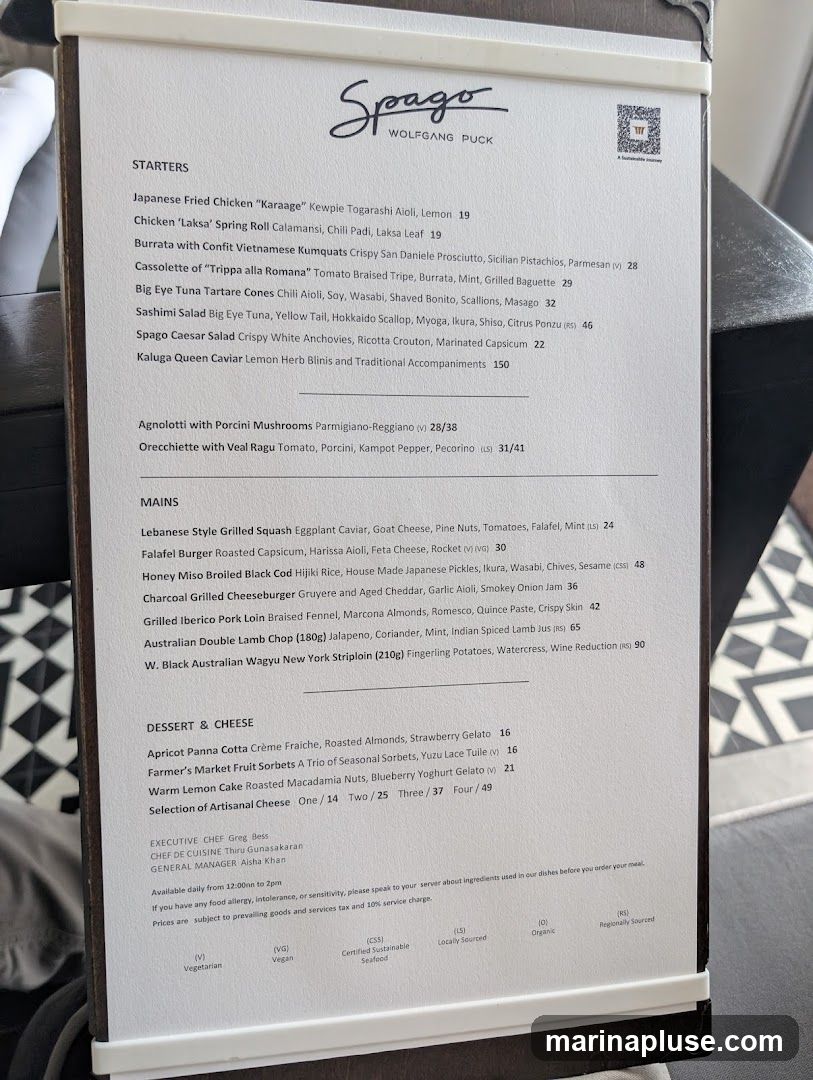 A menu from Spago by Wolfgang Puck, featuring starters, mains, and desserts.