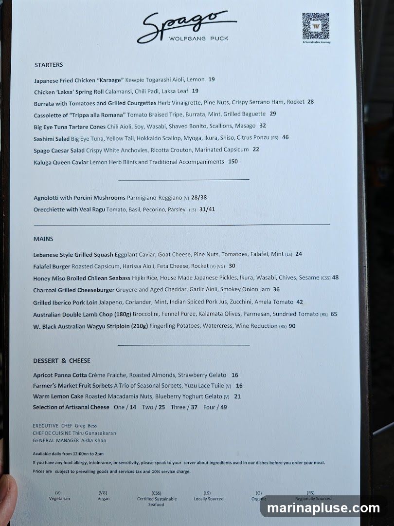 A menu from Spago Wolfgang Puck with starters, mains, and desserts.