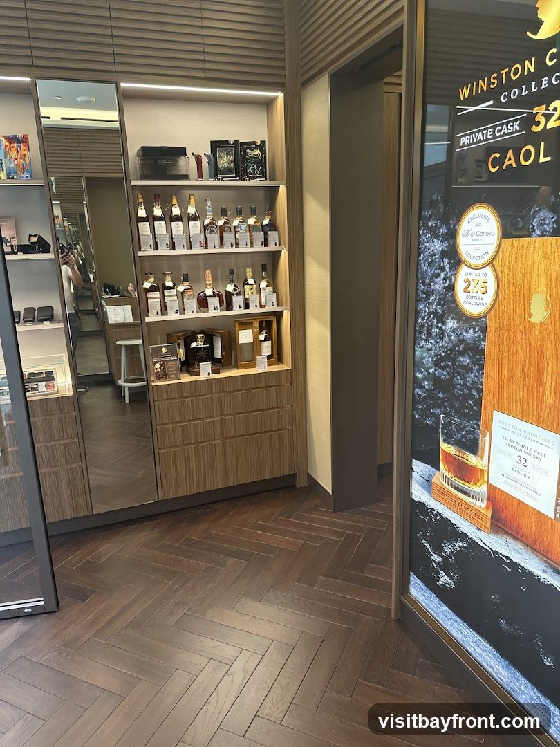A display of various bottles of whiskey on shelves in a store. There is a large advertisement on the right side of the image for Winston Churchill Collection, featuring a bottle of Islay Single Malt Scotch Whisky, Caol Ila, 32 years old, private cask.