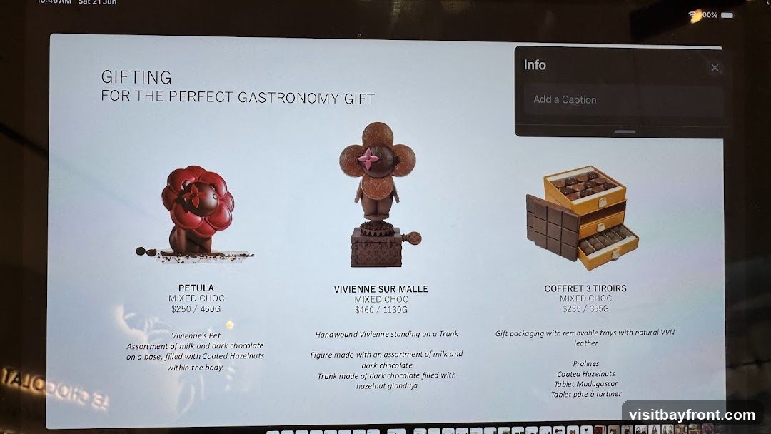 A display of luxury chocolates for gifting. Features three items: Petula, Vivienne sur Malle, and Coffret 3 Tiroirs, with descriptions and prices.