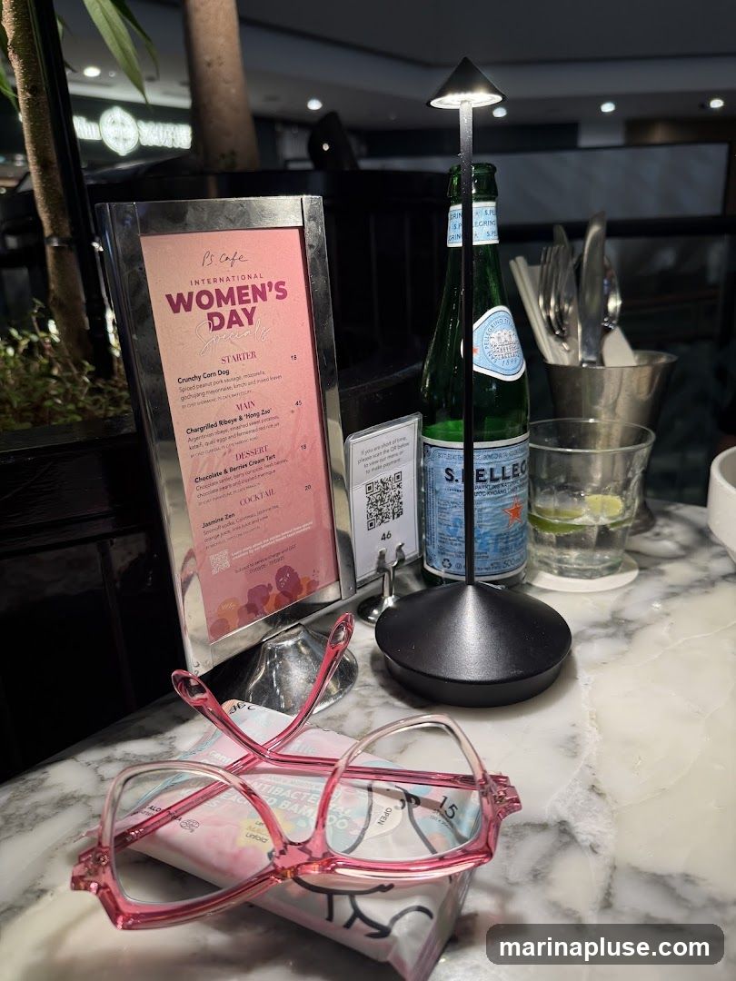 A menu board displaying specials for International Women's Day at PS. Cafe. It includes starters, mains, desserts, and cocktails.