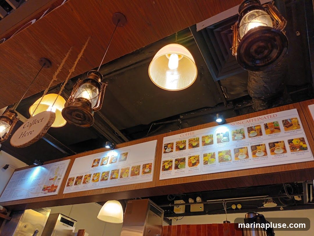 A menu board displaying various coffee and tea options, along with refreshing beverages. The menu is divided into sections for Coffee, Non-Caffeinated Local Favourites, and Tea. Each item is accompanied by a small image.
