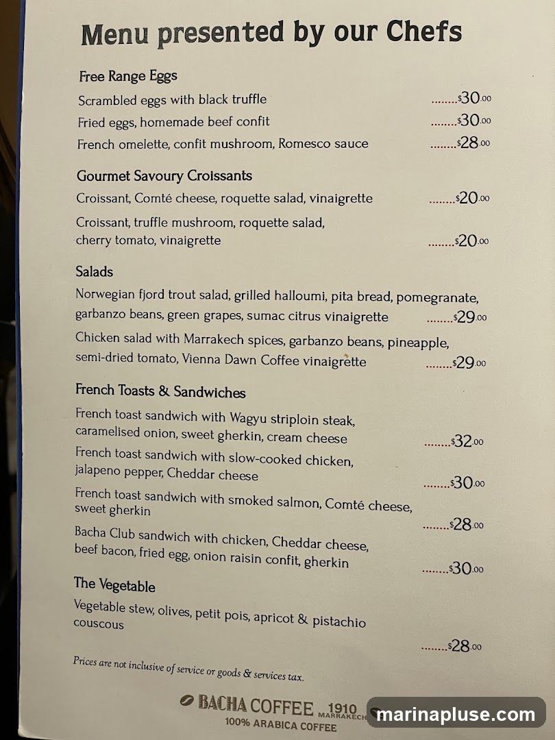 A menu with sections for Free Range Eggs, Gourmet Savoury Croissants, Salads, French Toasts & Sandwiches, and The Vegetable. The bottom of the menu includes the Bach Coffee logo and information.