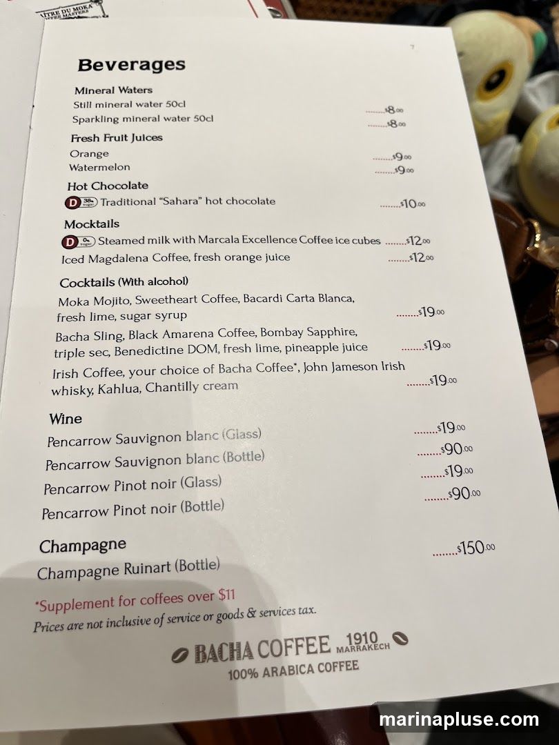 A menu page listing various beverages including mineral waters, fresh fruit juices, hot chocolate, mocktails, cocktails, wine, and champagne.