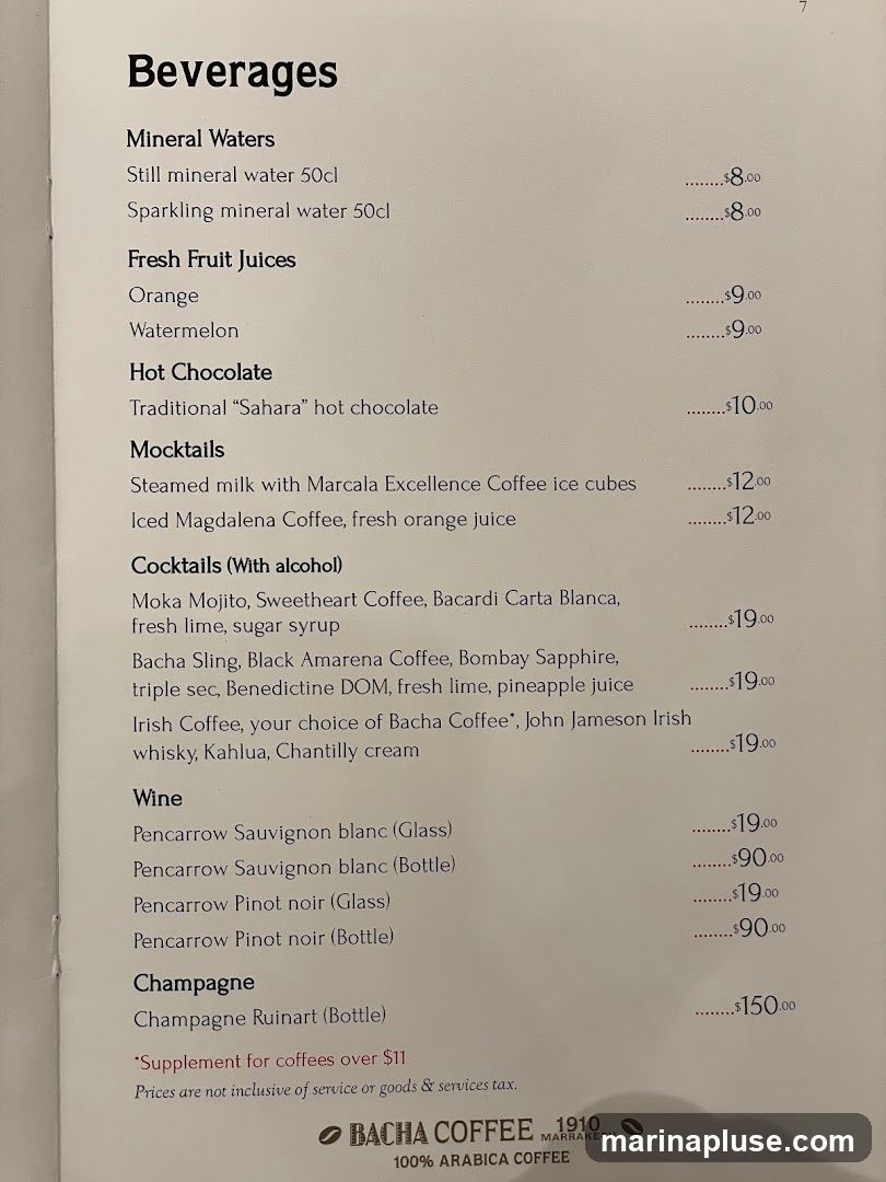 A menu page listing various beverages including mineral waters, fresh fruit juices, hot chocolate, mocktails, cocktails, wine, and champagne.