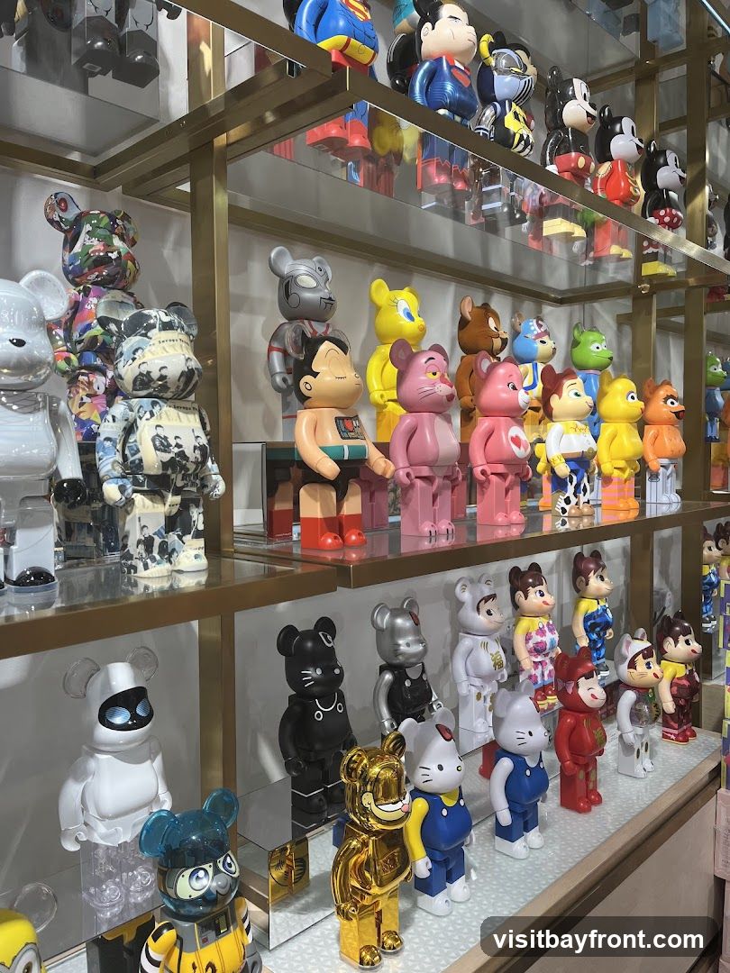 Shelves filled with various collectible figurines, including characters like Superman, Mickey Mouse, Astro Boy, and Hello Kitty. The figurines are displayed in a retail setting, likely a toy store or collectible shop.