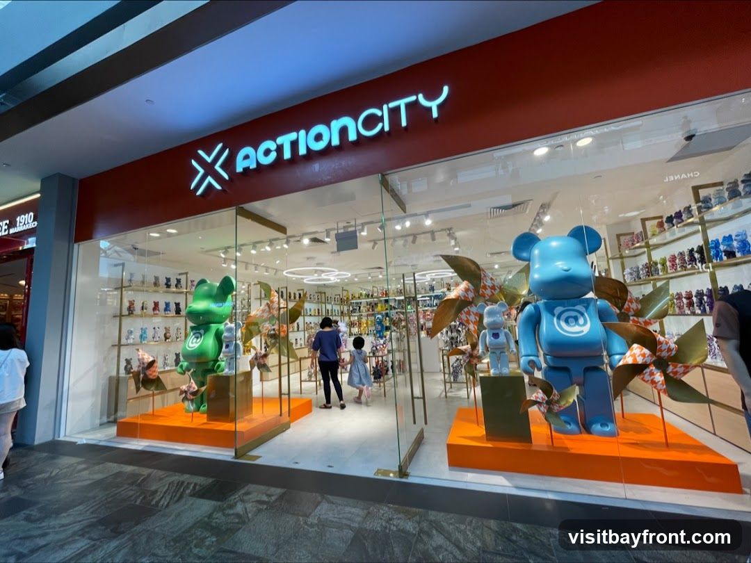 The exterior of the Action City store features a bright red facade with the store's name illuminated in neon blue. Large display windows showcase various collectible toys, including prominent bear-shaped figures in green and blue. Inside, shelves are filled with more collectibles. Two people are seen entering the store.