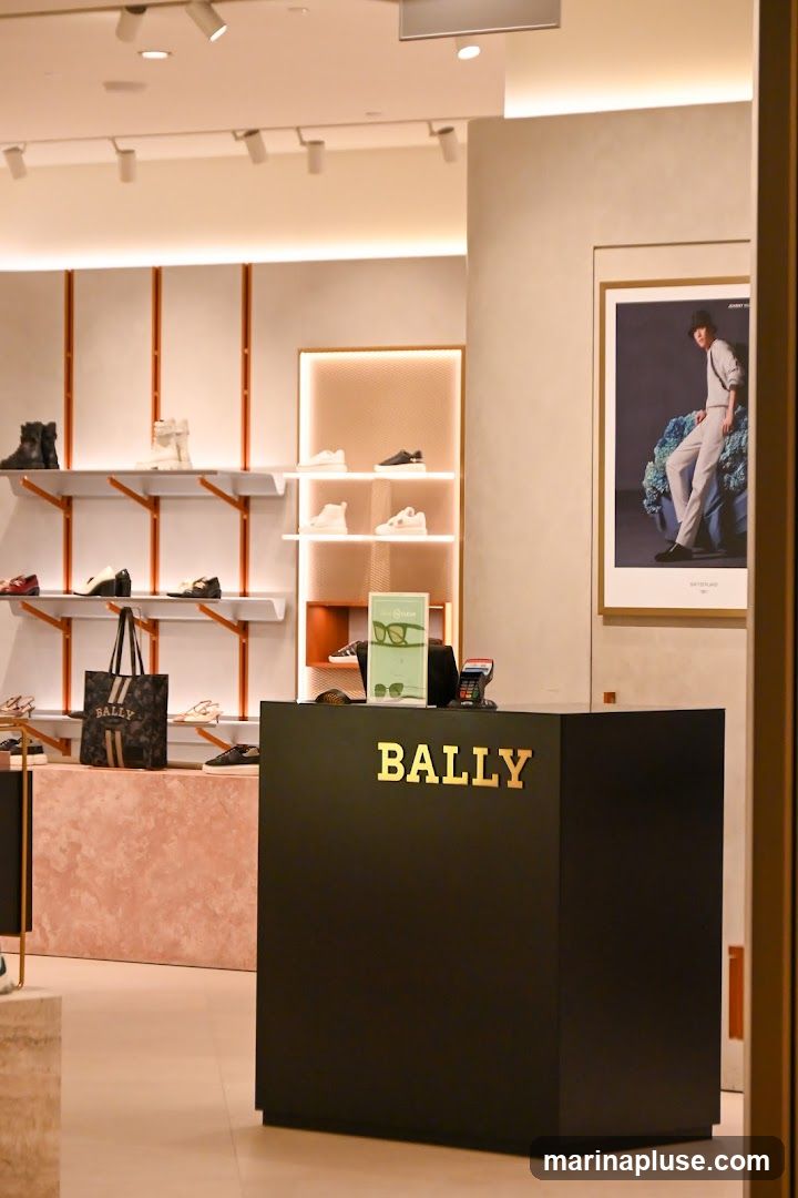A view inside a Bally store, showing a checkout counter with the Bally logo, shelves displaying shoes, and a promotional poster on the wall.