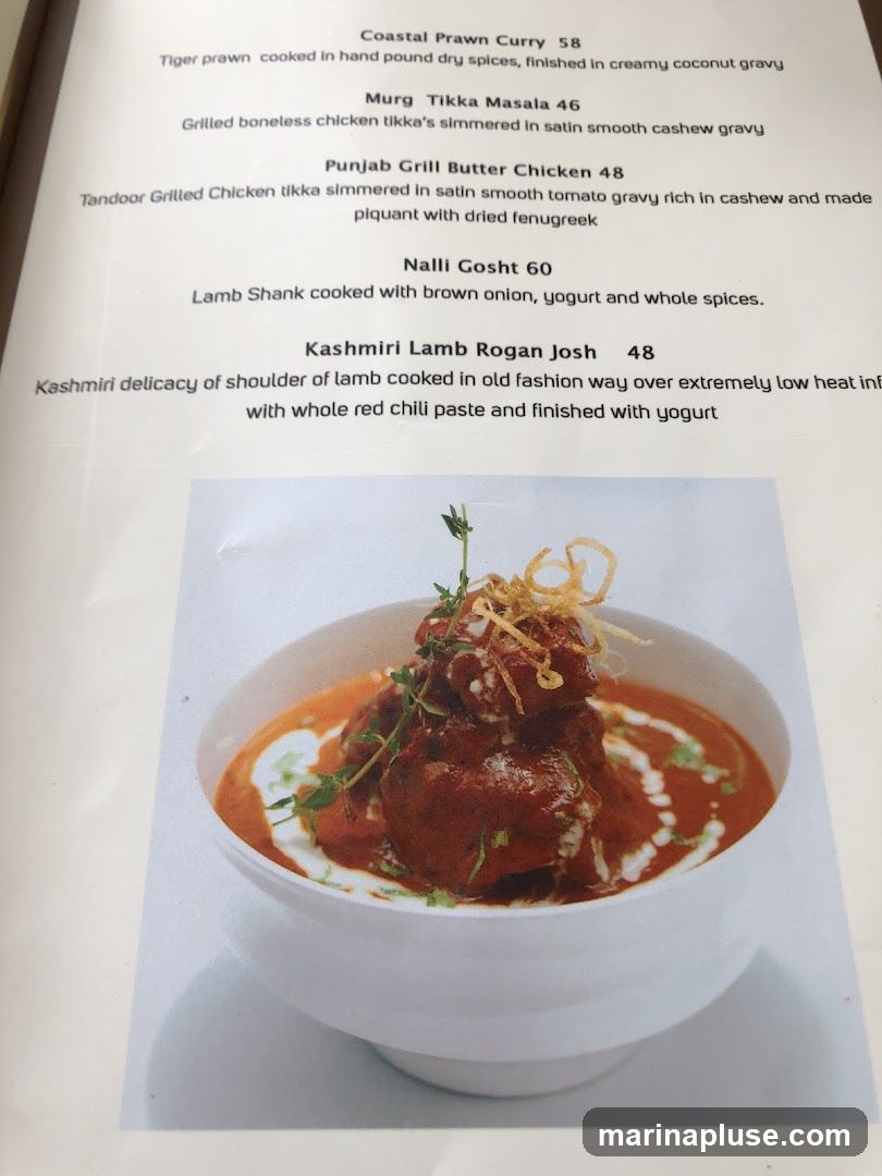 A menu featuring various Indian dishes with descriptions and prices.