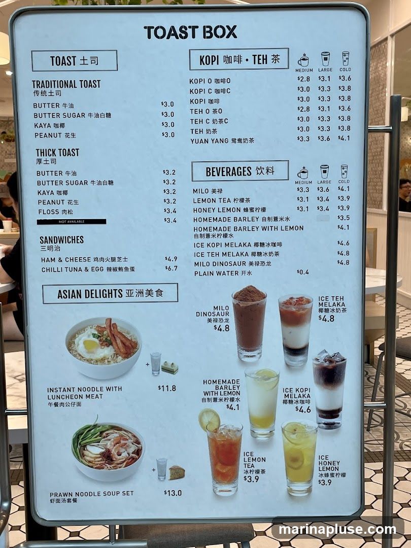 A menu board for Toast Box, featuring traditional toast, thick toast, sandwiches, Asian delights, Kopi, Teh, and beverages.