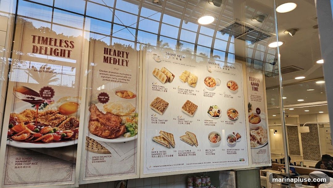A display of food menu items with images and descriptions. The menu is divided into sections such as 'Timeless Delight', 'Hearty Medley', 'Toast Sets', and 'Asian Delight Sets'. Featured items include Hainanese Pork Chop Rice, Spiced Drumstick Curry Rice, various toast sets with kaya, ham and egg, floss, and peanut, and Asian dishes like Curry Chicken Rice and Laksa.