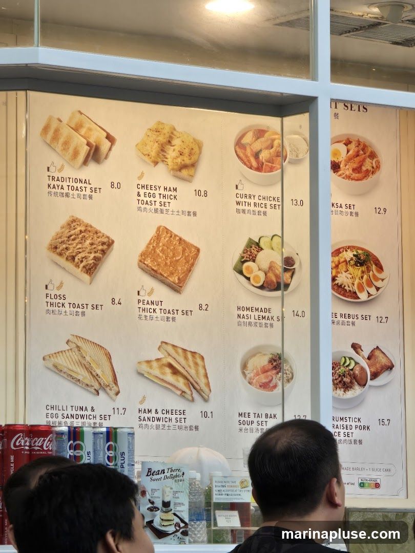 A menu board displaying various breakfast and meal sets with images and prices.