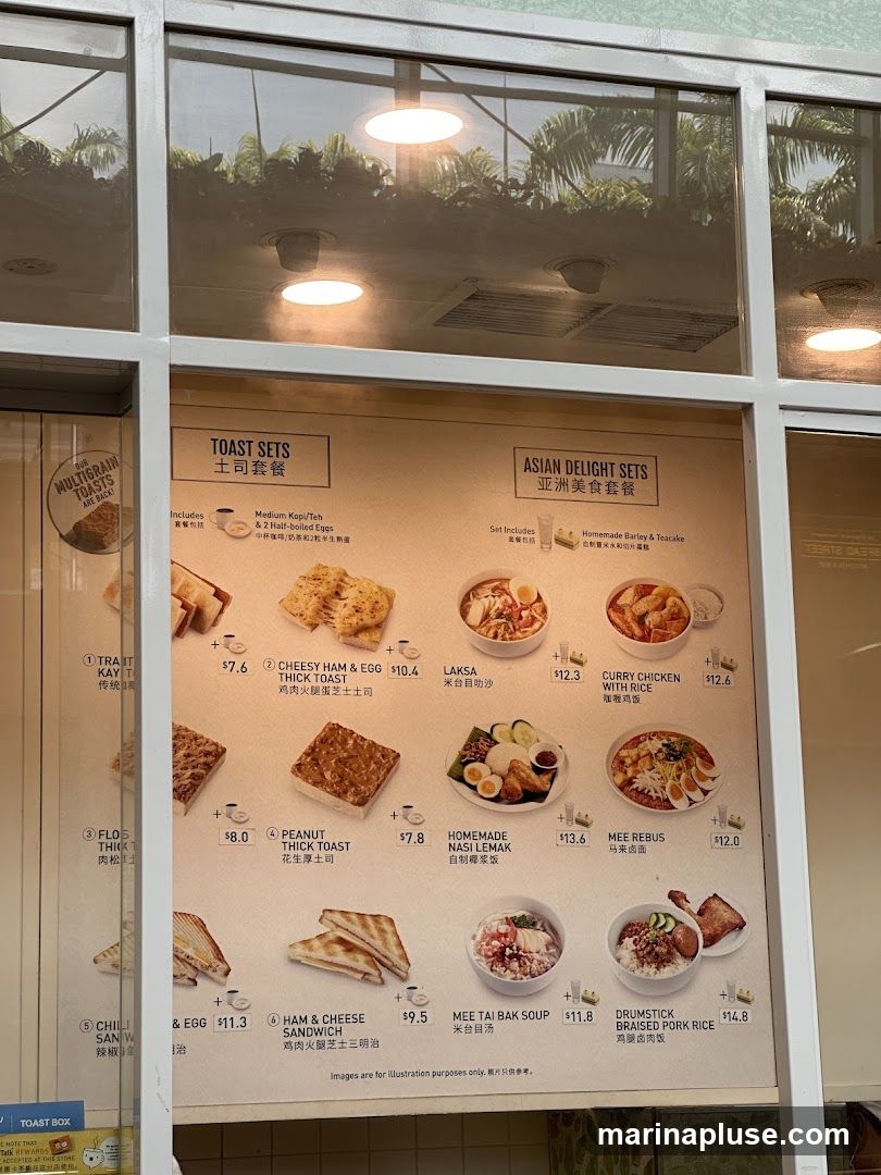 A menu board displaying various toast sets and Asian delight sets with prices.