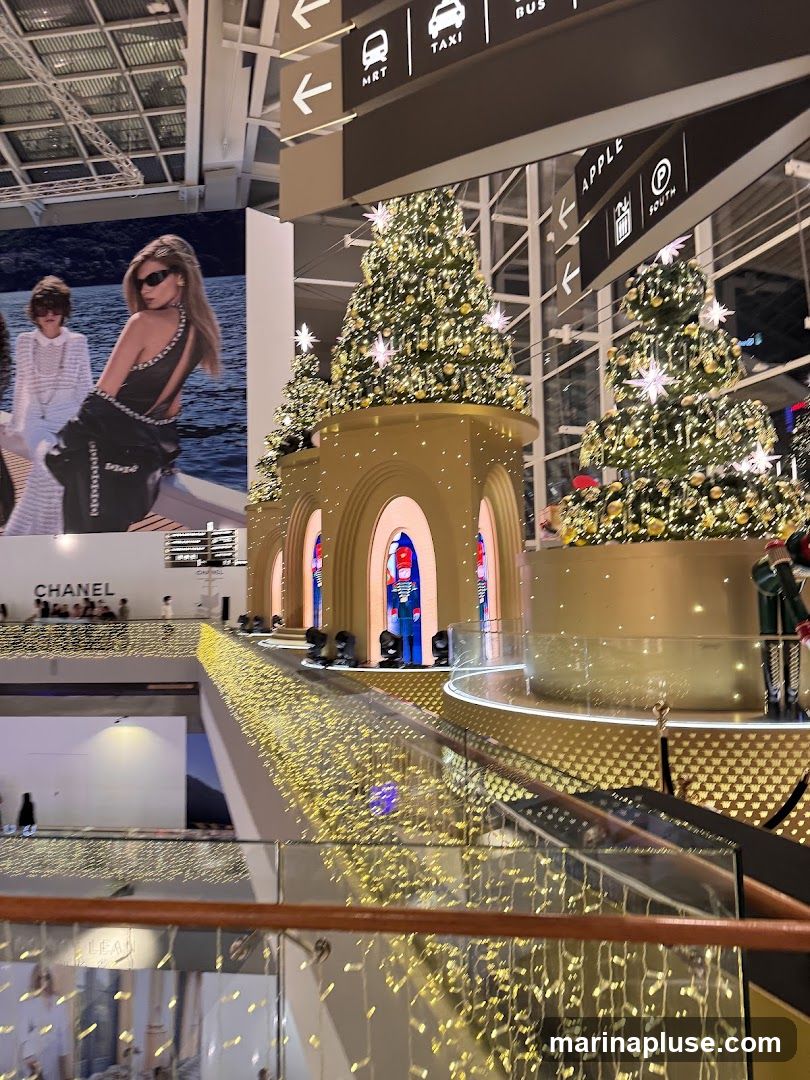 A festive indoor scene with multiple decorated Christmas trees, illuminated with golden lights and star-shaped ornaments. A large advertisement featuring models in fashionable attire is visible on the left, with the word