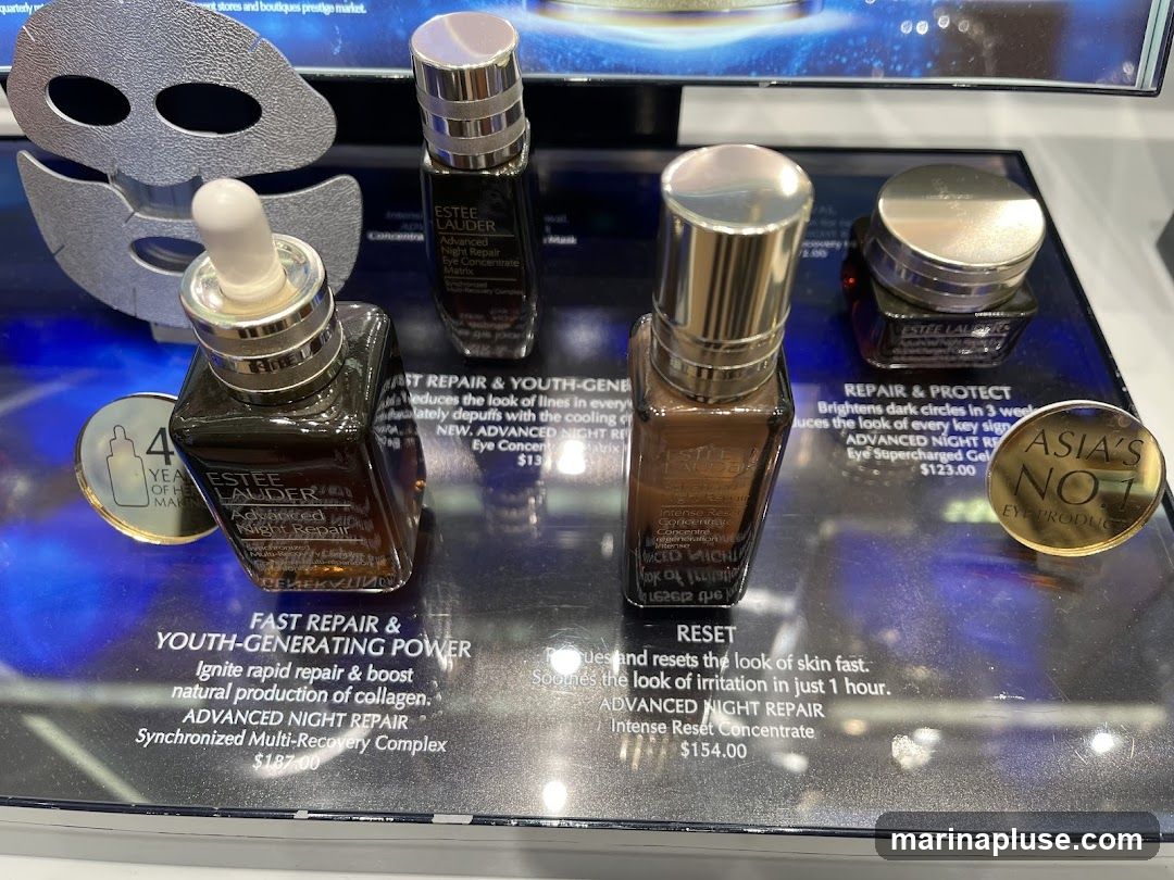 A display of Estee Lauder Advanced Night Repair products, including serum bottles and eye cream. Text describes product benefits and prices.