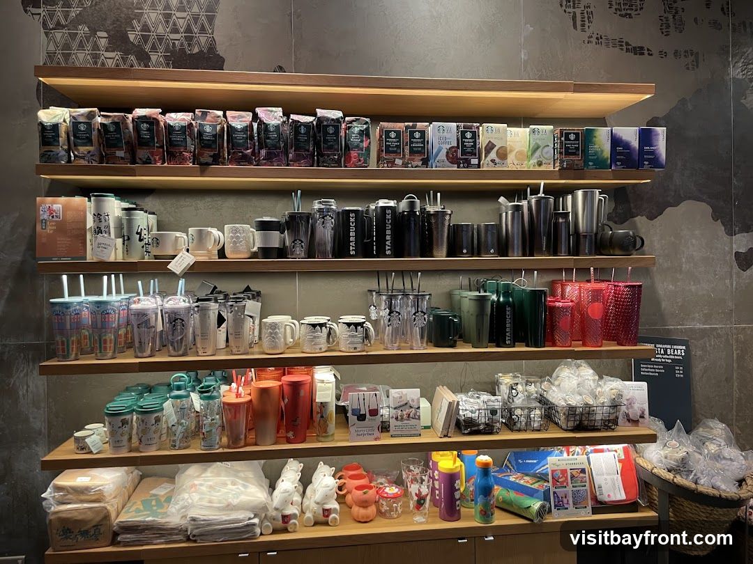 Shelves stocked with various Starbucks merchandise, including bags of coffee beans, tumblers, mugs, and other drinkware.