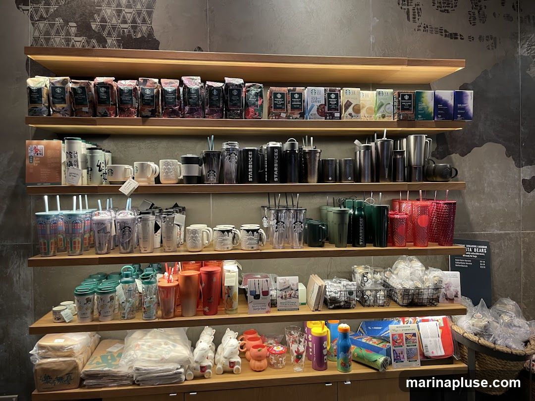 Shelves stocked with various Starbucks merchandise, including bags of coffee beans, tumblers, mugs, and other drinkware.