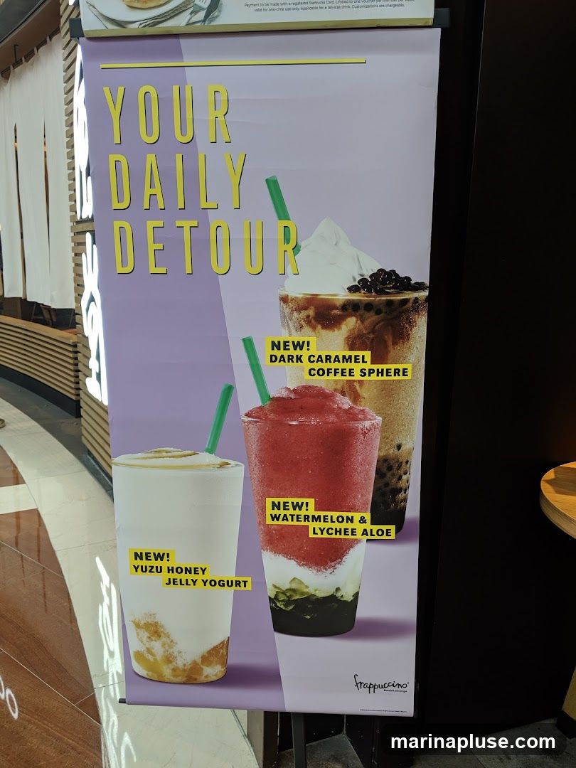 A promotional poster for Frappuccino blended beverages with the tagline "YOUR DAILY DETOUR". It features three drinks: Yuzu Honey Jelly Yogurt, Dark Caramel Coffee Sphere, and Watermelon & Lychee Aloe.