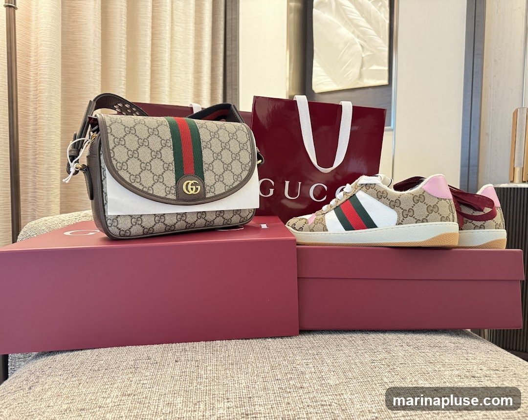 A Gucci crossbody bag and a pair of Gucci sneakers are displayed on top of red boxes. A red Gucci shopping bag is in the background.