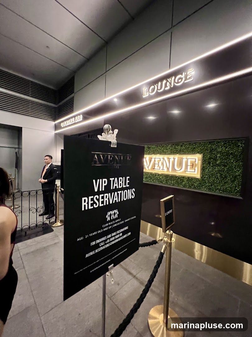 A sign for VIP table reservations is displayed outside a venue with "LOUNGE" and "AVENUE" signage visible. A staff member in a suit stands near the entrance.