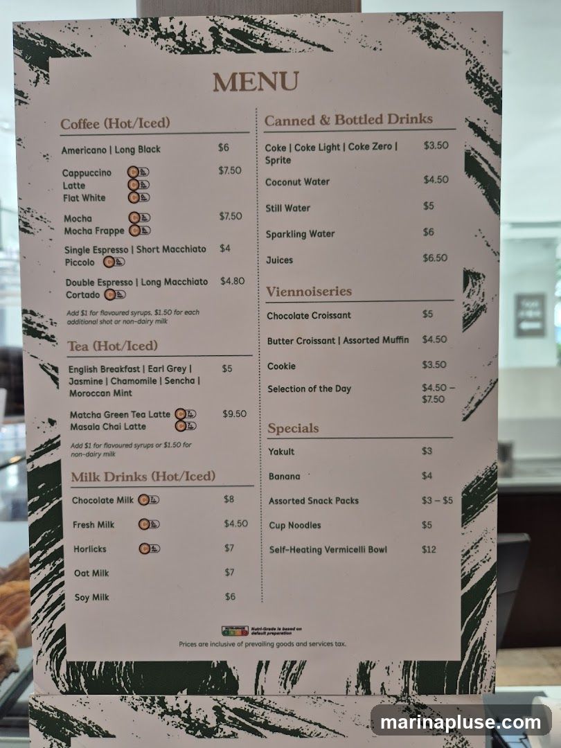 A menu with sections for Coffee, Tea, Milk Drinks, Canned & Bottled Drinks, Viennoiseries, and Specials.