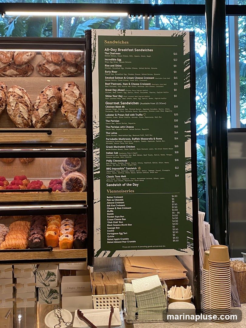 A menu board displaying a variety of sandwiches and viennoiseries.