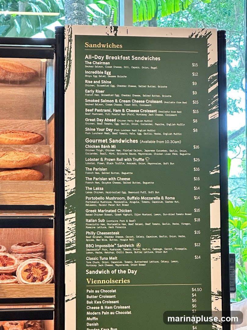 A menu board displaying various sandwiches and viennoiseries.