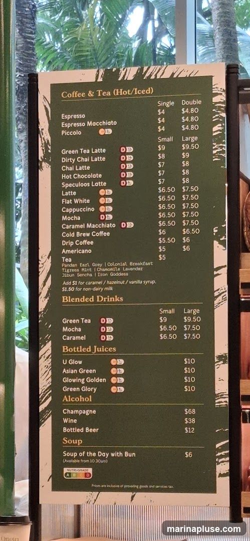 A menu board displaying coffee, tea, blended drinks, bottled juices, alcohol, and soup options.