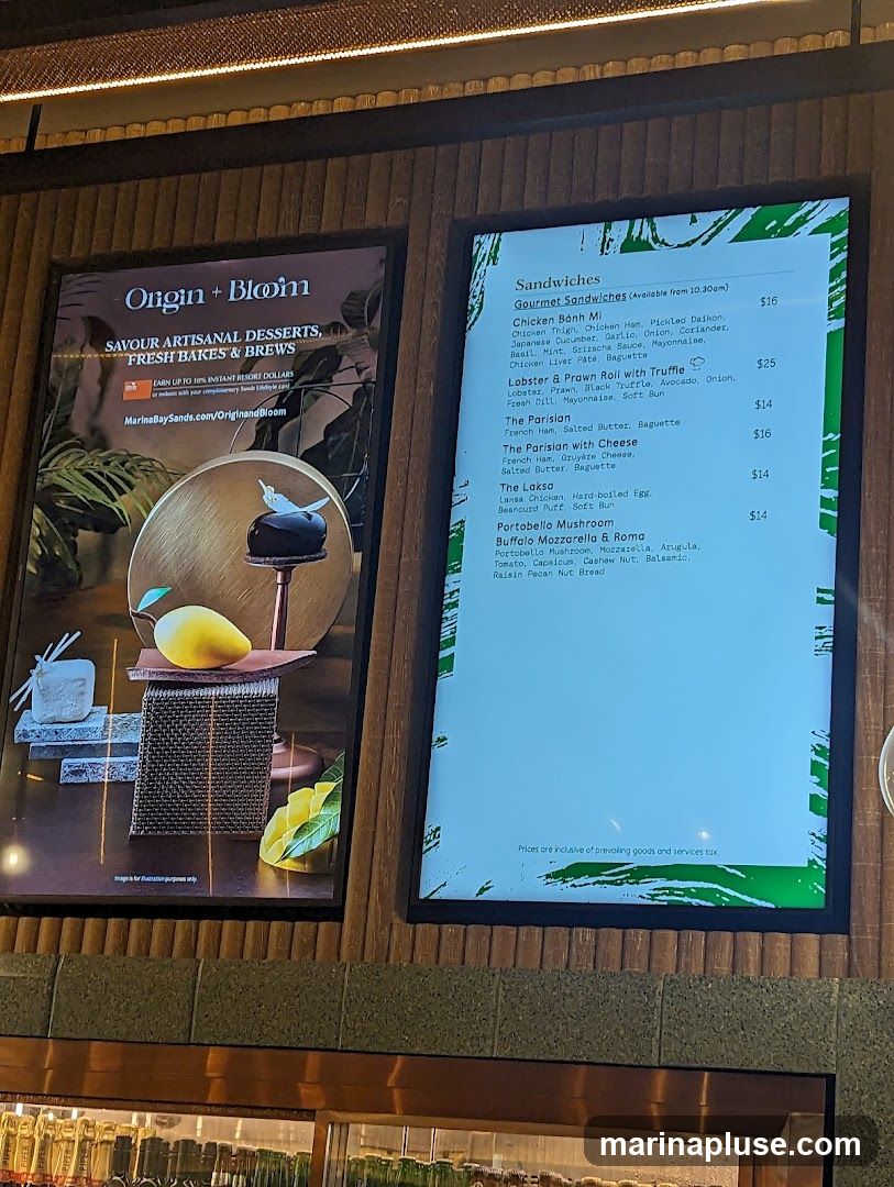 A digital menu board displaying gourmet sandwiches.