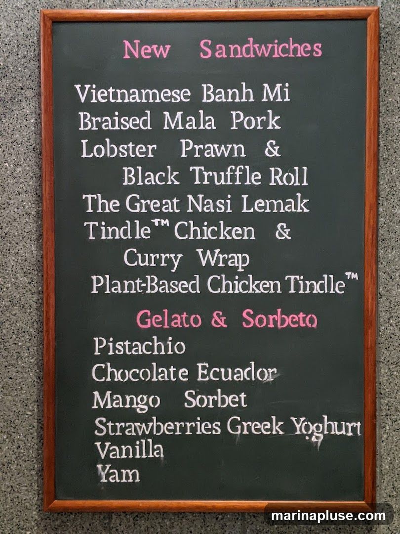 A chalkboard menu listing new sandwiches and gelato/sorbet flavors.
