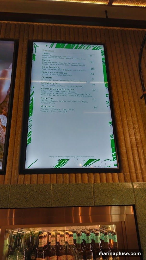 A digital menu displaying pastries and bubble tea with prices.