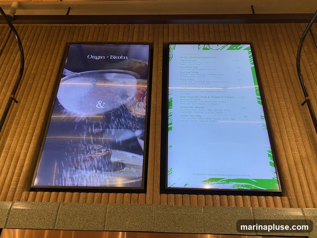 A digital menu board displaying breakfast sandwiches and other items.