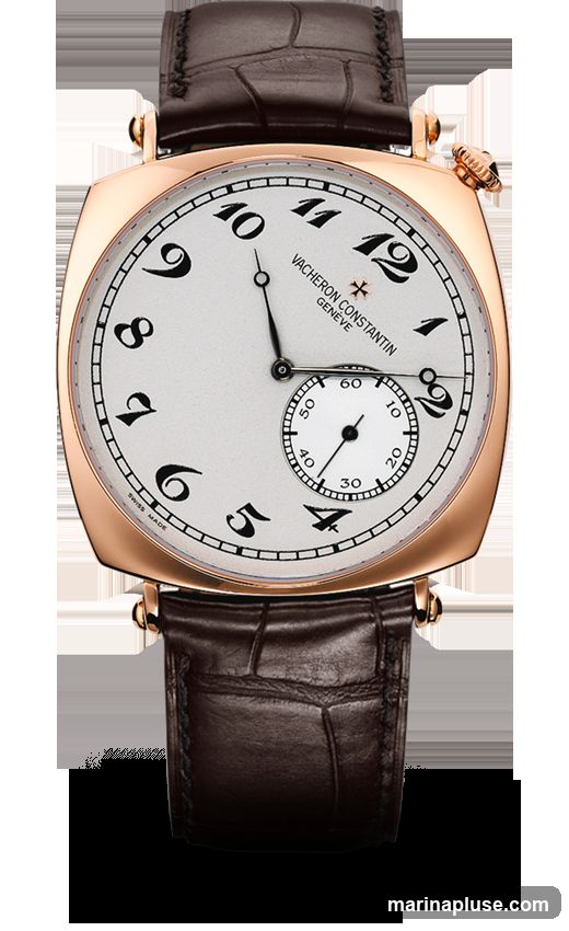 A close-up, studio shot of a Vacheron Constantin watch with a white dial, black Arabic numerals, and a small seconds subdial. The watch has a rose gold case and a brown alligator leather strap. The brand name and "Genève" are visible on the dial.