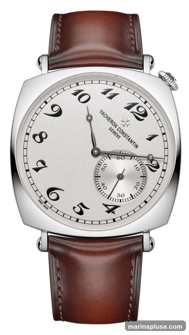 A close-up studio shot of a Vacheron Constantin watch with a silver dial and brown leather strap. The watch features Arabic numerals for hours, a small seconds subdial at 6 o'clock, and the brand's name and Geneva inscription on the dial. The strap is stitched with contrasting thread.