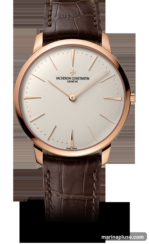 A close-up studio shot of a Vacheron Constantin watch with a rose gold case and a light-colored dial. The watch has a brown alligator leather strap. The brand name and 'Geneve' are visible on the dial, along with 'Swiss Made' at the bottom.