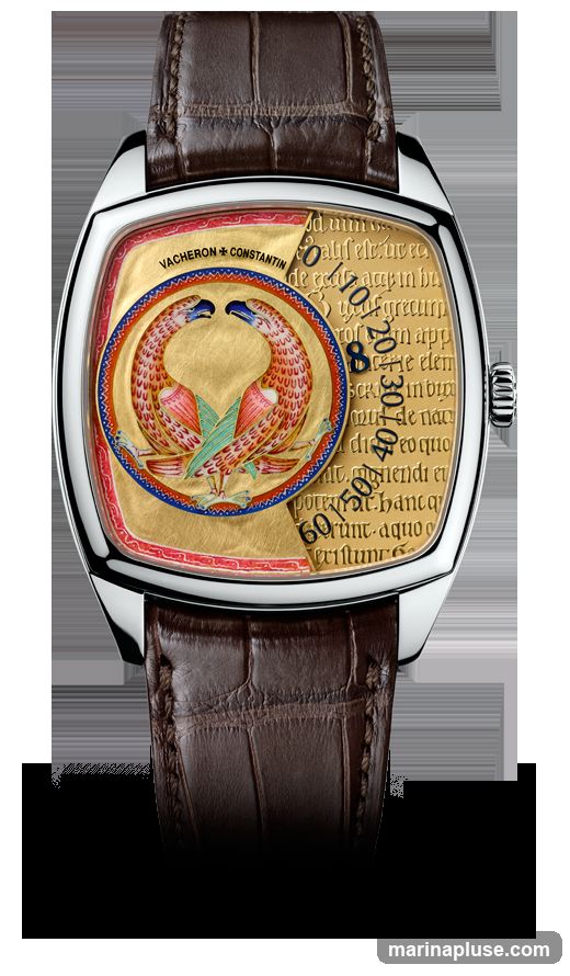 A close-up studio shot of a Vacheron Constantin watch with a brown alligator leather strap. The watch face is gold with intricate detailing. A circular motif of two stylized birds facing each other is at the center, surrounded by a red and blue border. The background of the watch face features text in a script font, with some numbers visible, indicating a time-telling function. The watch has a silver-toned case and a crown on the right side.