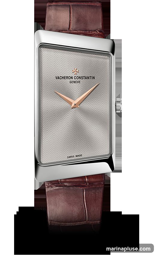 A close-up studio shot of a Vacheron Constantin Geneve watch with a silver patterned dial and rose gold hands. The watch has a rectangular silver case and a brown alligator leather strap. The words "SWISS MADE" are visible at the bottom of the dial.