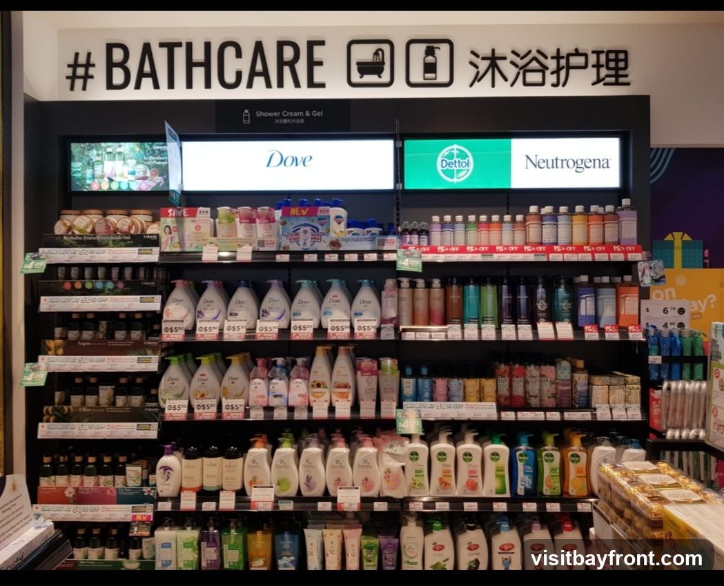 A retail display featuring a wide variety of bath and body products, including shower creams, gels, lotions, and soaps. Brands visible include Dove, Dettol, and Neutrogena. Promotional signs indicating discounts are also present.