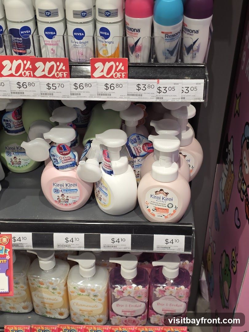 A retail display featuring various personal care products, including deodorants and hand soaps. The top shelf shows several Nivea and Rexona deodorants, with some marked with "20% OFF" sale tags. Below, multiple bottles of Kirei Kirei foaming hand soap in different scents like peach and antibacterial are arranged. The bottom shelf displays more hand soaps, labeled "Chamomile" and "Rose & Orchid," also with price tags indicating $4.10.