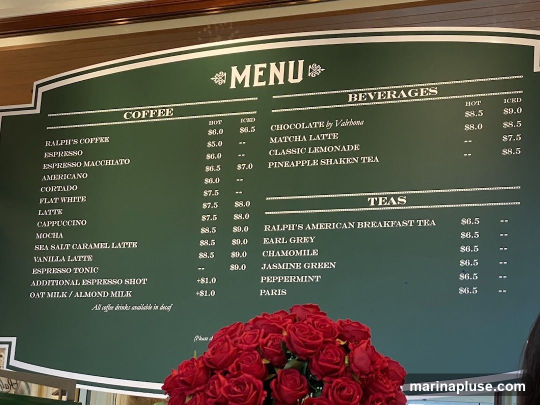 A green menu board with white text listing coffee, beverages, and teas.