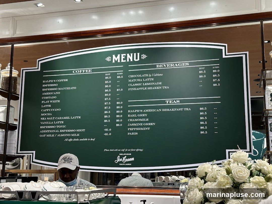 A green menu board with white lettering displays coffee, beverages, and tea options.