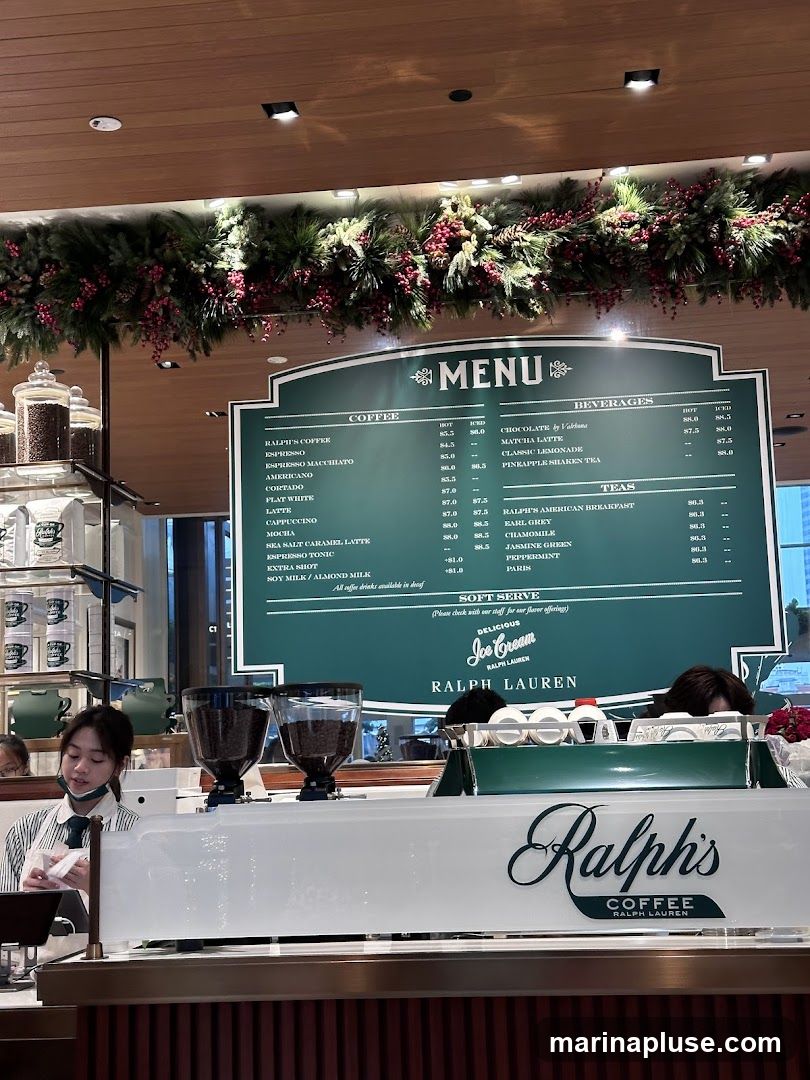 A menu board displays coffee, beverages, and tea options. Festive garland is visible above the menu.