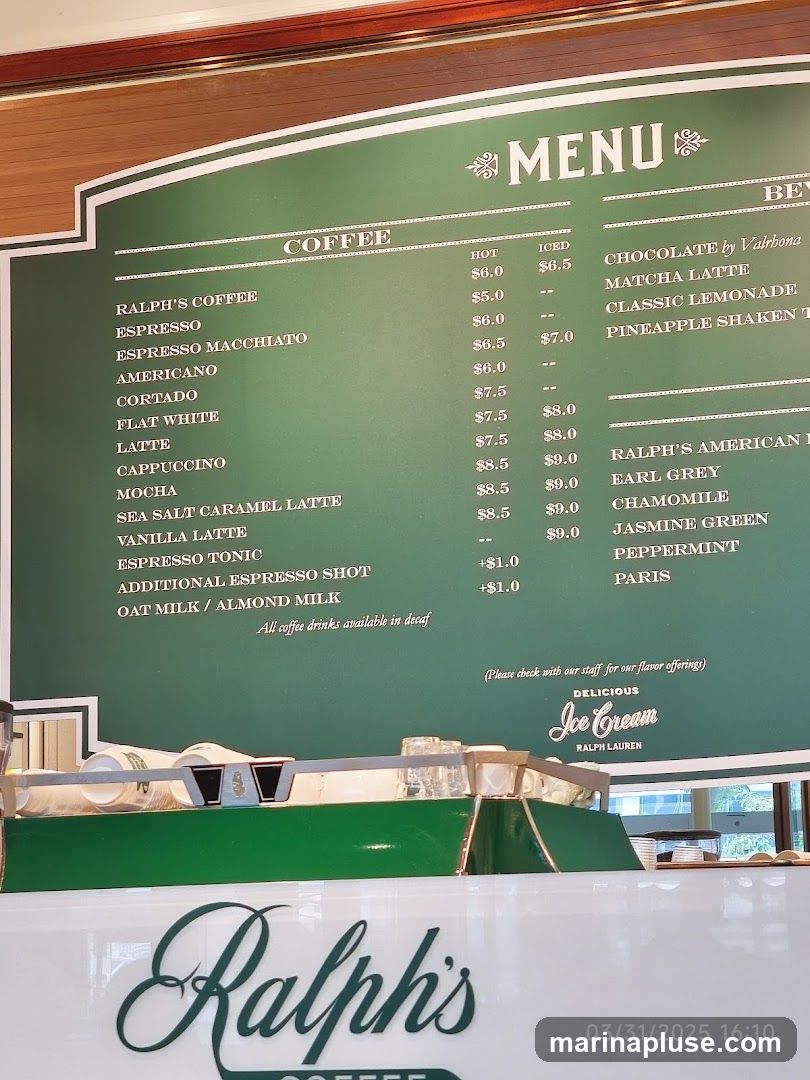A green menu board with white text lists coffee and beverage options. Below the menu, a white counter with the "Ralph's" logo is visible.