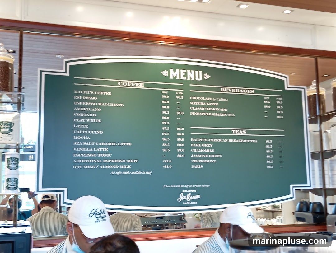 A green menu board displays coffee, beverages, and teas with prices.