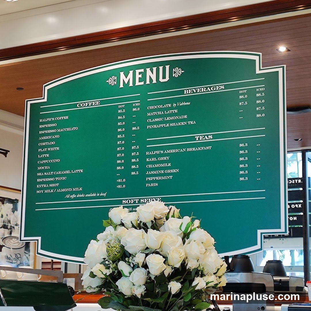A green menu board with white text listing coffee, beverages, and teas.