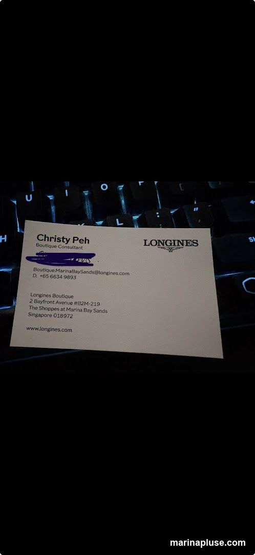 A business card for Christy Peh, a Boutique Consultant at Longines Boutique. The card includes contact information such as email, phone number, and the boutique's address at The Shoppes at Marina Bay Sands in Singapore. The Longines logo is visible on the card.