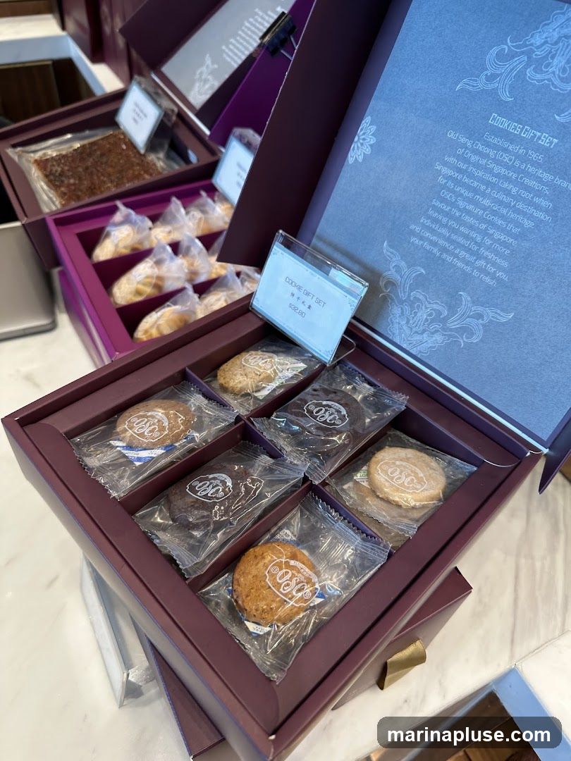 A gift box containing individually wrapped cookies. The box is purple and has a lid that opens to reveal a description of the cookie gift set. The cookies appear to be of different flavors and textures. A small sign indicates the price of the cookie gift set.